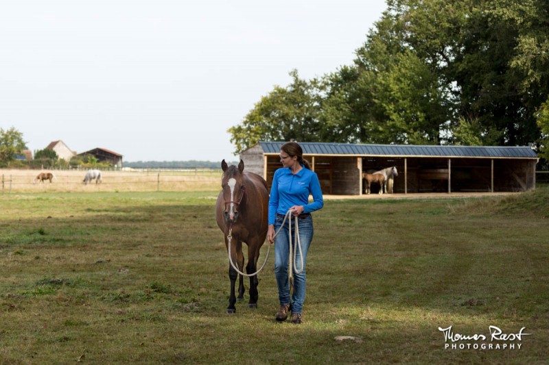 Gabi Neurohr young horse education - a horse trainer takes her foal in hand away from the herd  